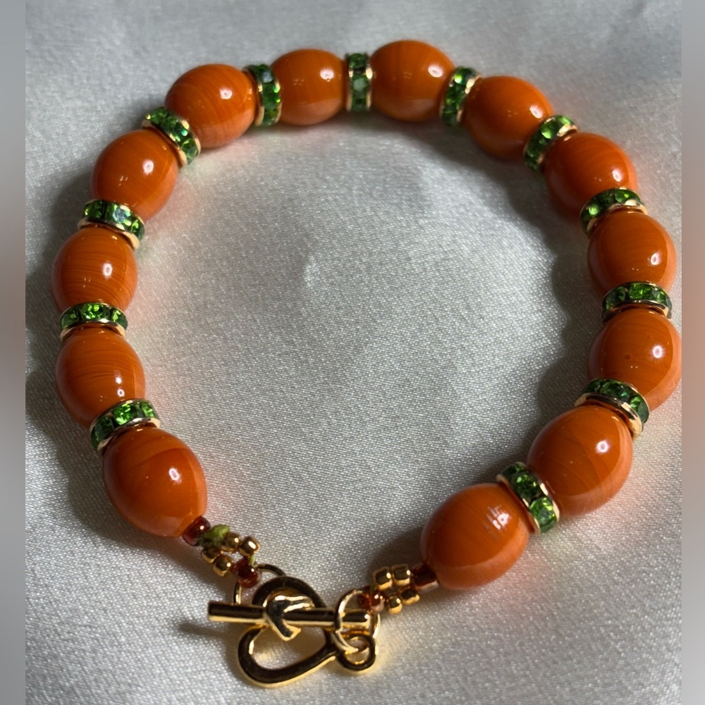 Orange Indian Lamp Work Beaded Bracelet with Green Rhinestones. 7.5 inches